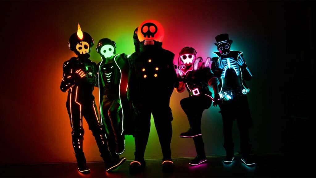 The Living Tombstone in signature skull costumes and neon LED suits, promotional photo for The Multiplayer Tour