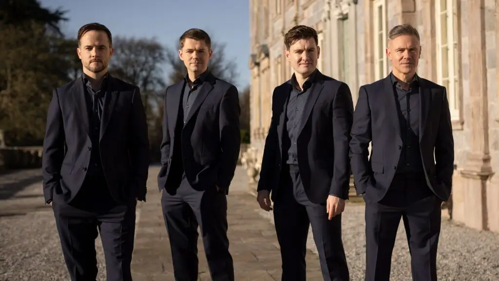 Celtic Thunder four-man ensemble in navy suits at a historic estate, promotional photo