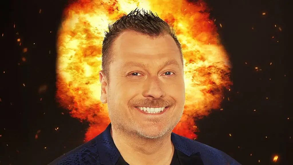 Jimmy Failla comedy tour promotional photo, smiling in blue blazer with dramatic backdrop
