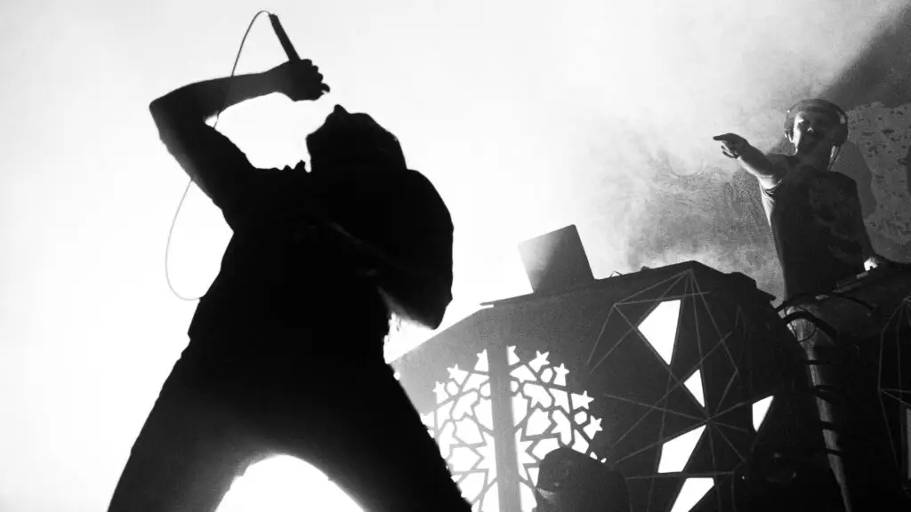 Igorrr performing live on stage, vocalist and electronic musician in dramatic black-and-white concert photo