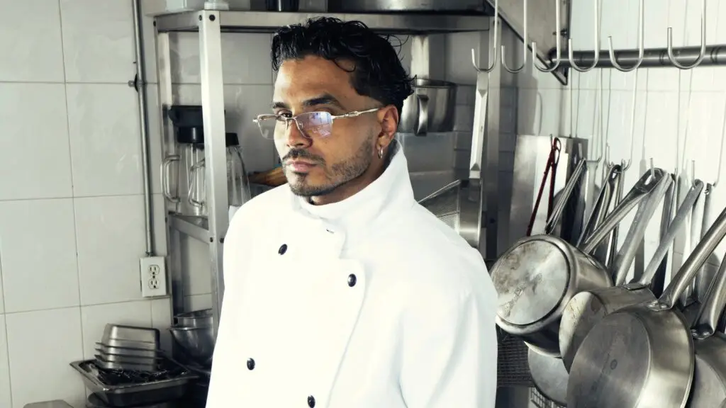 Álvaro Díaz in chef coat posing in professional kitchen, promotional image for OMAKASE Tour