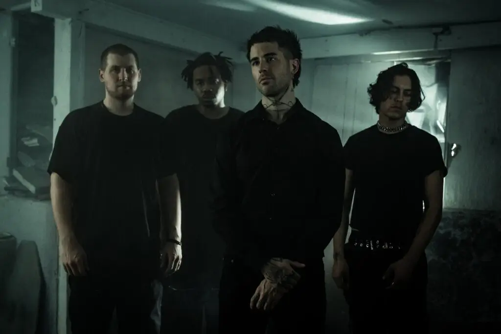 Holywatr band members posed in a dark industrial setting, official press photo
