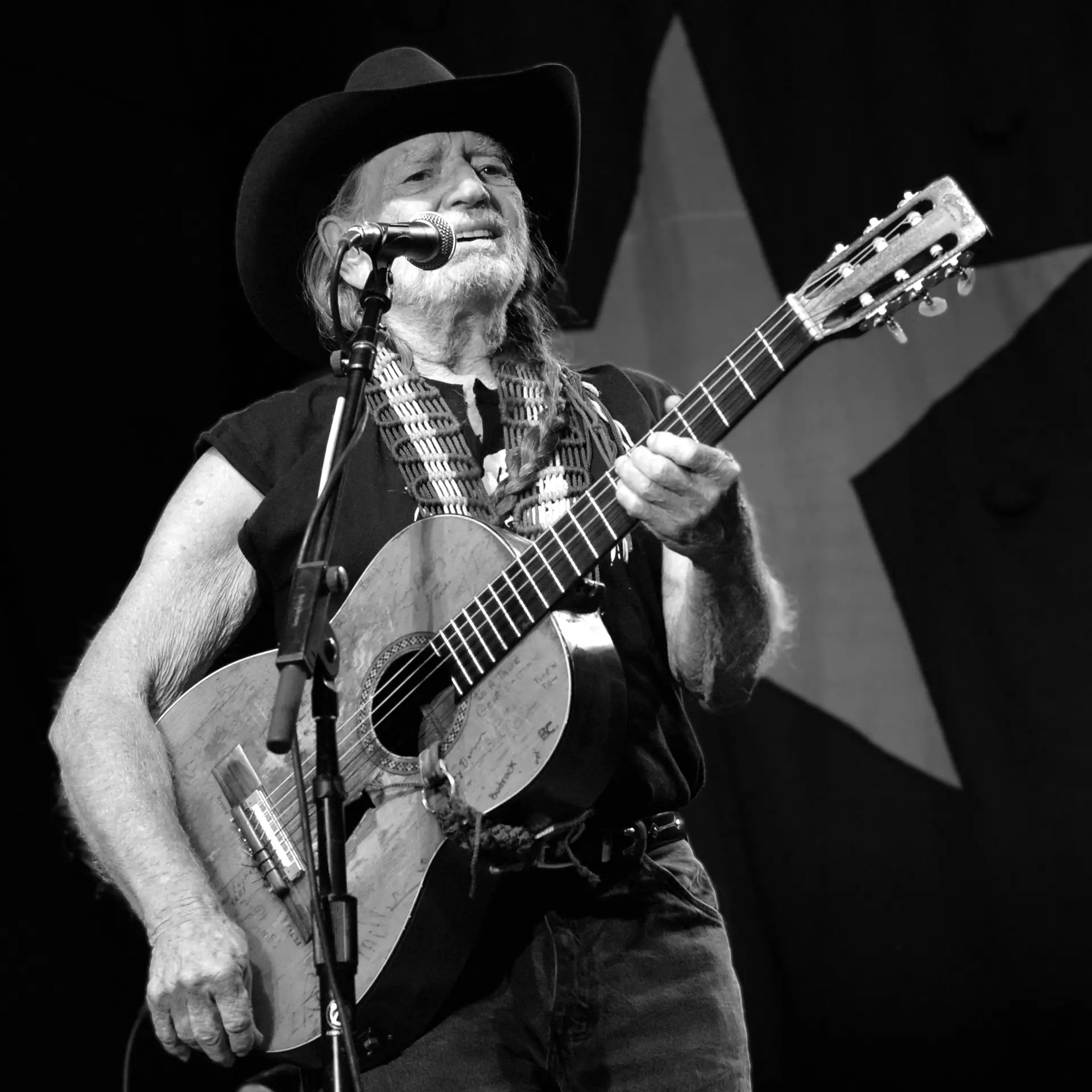 Willie Nelson performing with his guitar Trigger