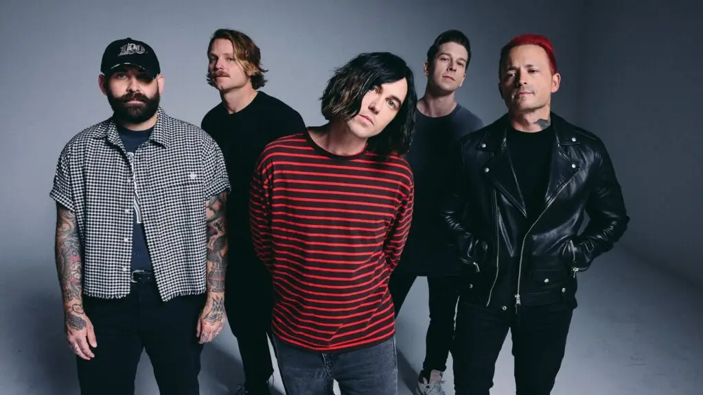 Sleeping With Sirens band press photo featuring Kellin Quinn and four bandmates in studio