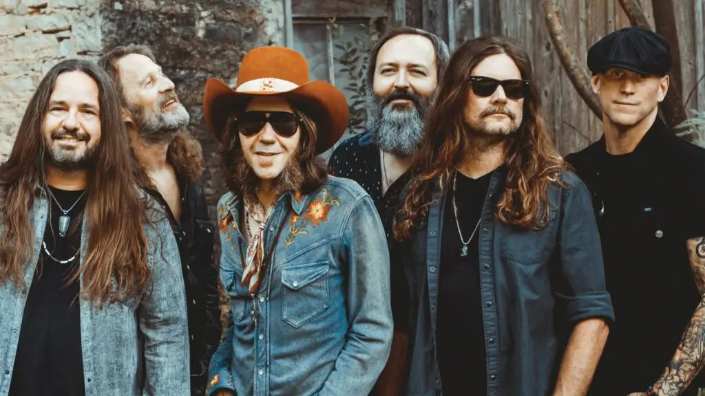 Blackberry Smoke band press photo, five members posed outdoors against rustic stone wall