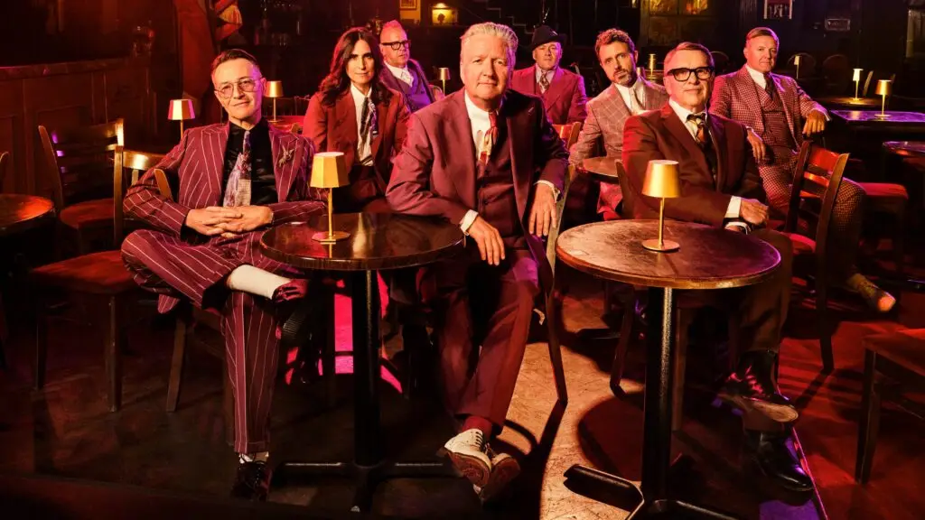 Squeeze — eight-piece band in nightclub setting, warm red lighting, Trixies Tour 2026