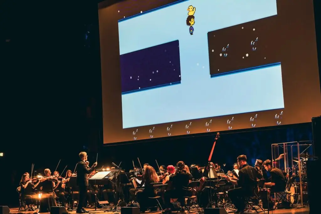 Undertale: The Determination Symphony orchestra performing live with Undertale gameplay projected on screen above stage