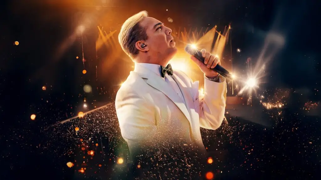 Cristian Castro performing live, singing in white tuxedo jacket with mic, concert crowd behind him