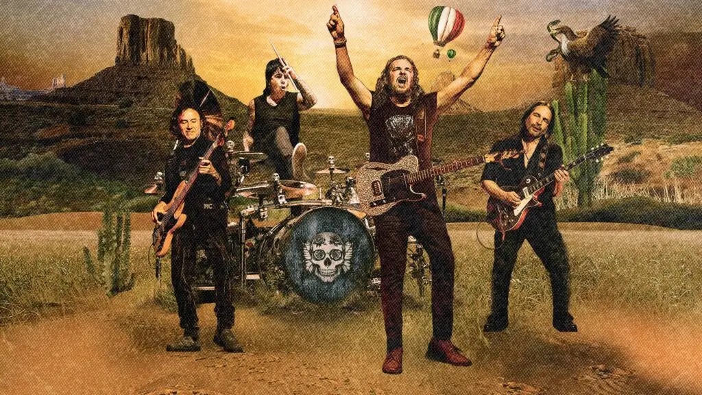 MANÁ band promo photo, four members in stylized desert landscape, vocalist Fher Olvera arms raised